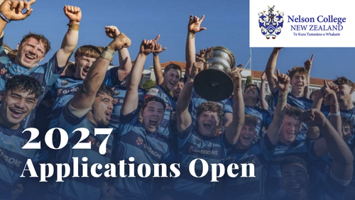 Rugby team with hands in the air holding up a trophy.